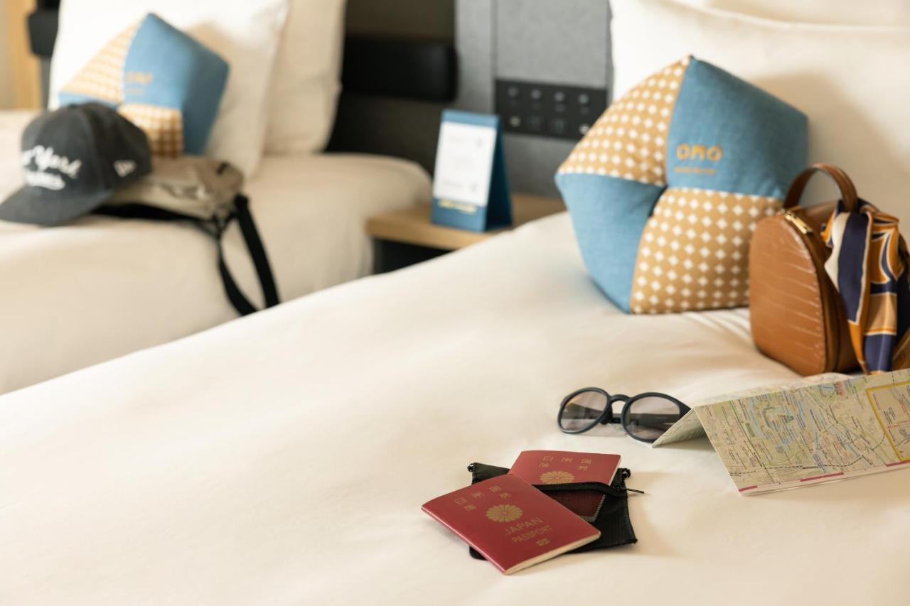 Omo Kansai Airport By Hoshino Resorts Izumisano Luaran gambar A passport and a boarding pass on a bed